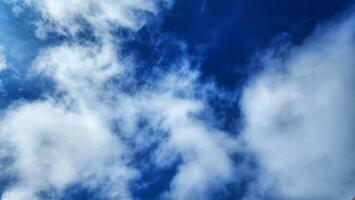 a view of the sky with clouds and a plane photo