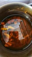 a pan filled with liquid and vegetables photo