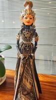 Wayang golek is a three-dimensional performing art made from wood that is carved to resemble humans, then dressed up with cloth as clothing to make it more attractive. photo