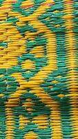 Yellow and green wicker mat texture. Abstract background and texture for design. photo