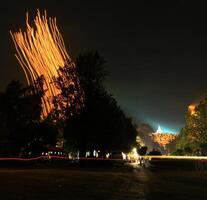 a large tree in the background with light low shutter speed camera photo