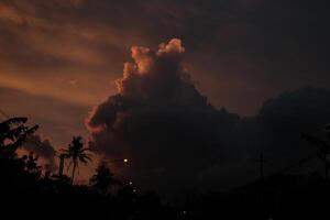 a cloud is seen in the sky over a street photo