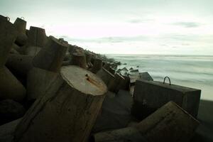 a pile of concrete blocks on the beach photo