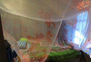 A Man Is Sitting In A Room With A Plastic Bag photo