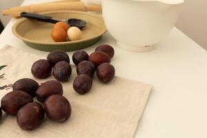 plum pie ingredients in plates, baking and cooking at home photo