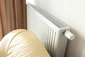 modern radiator for heating in the apartment with power regulators. ideal for those costs of heating and utilities in winter, warmth and comfort in the apartment photo
