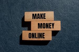 Make money online message written on wooden blocks with gray background. Conceptual make money online symbol. Copy space. photo