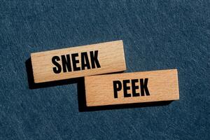 Sneak peek message written on wooden blocks with gray background. Conceptual sneak peek symbol. Copy space. photo