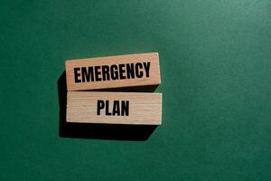 Emergency plan message written on wooden blocks with green background. Conceptual emergency plan symbol. Copy space. photo