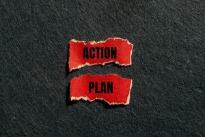 Action plan message written on ripped torn red paper pieces with gray background. Conceptual action plan symbol. Copy space. photo