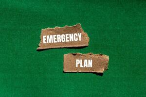 Emergency plan message written on ripped torn paper pieces with green background. Conceptual emergency plan symbol. Copy space. photo