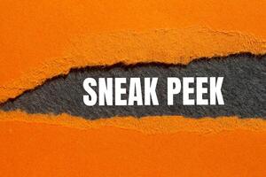 Sneak peek message written on ripped torn paper orange with gray background. Conceptual sneak peek symbol. Copy space. photo