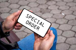 Special order message written on smartphone screen. Conceptual special order symbol. Copy space. photo