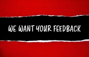 We want your feedback message written on ripped torn red paper with black background. Conceptual we want your feedback symbol. Copy space. photo