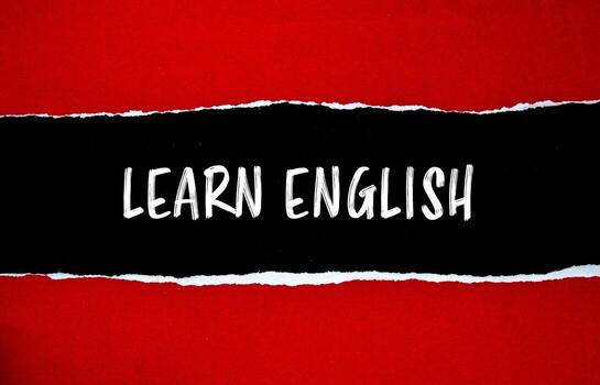 Learn english message written on ripped torn red paper with black background. Conceptual learn english symbol. Copy space. photo