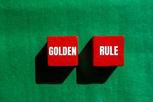 Golden rule message written on red wooden cubes with green background. Conceptual golden rule symbol. Copy space. photo