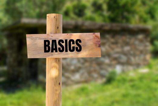 Basics message written on wooden sign with nature background. Conceptual basics symbol. Copy space. photo