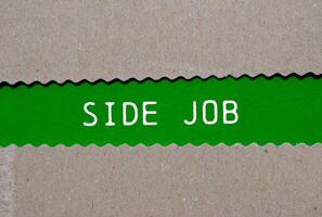 Side job message written on ripped torn paper on green background. Conceptual side job symbol. Copy space. photo