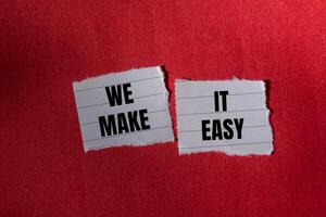 We make it easy message written on ripped torn paper piece with red background. Conceptual we make it easy symbol. Copy space. photo