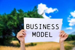 Business model message written on white paper with nature background. Conceptual business model symbol. Copy space. photo