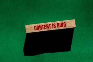 Content is king message written on wooden block with green background. Conceptual content is king symbol. Copy space. photo