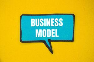 Business model message written on blue paper speech bubble with yellow background. Conceptual business model symbol. Copy space. photo