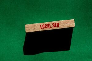 Local seo message written on wooden block with green background. Conceptual local seo symbol. Copy space. photo