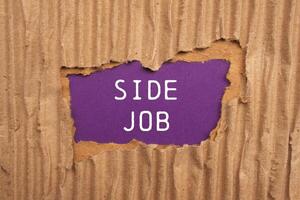 Side job message written on ripped torn cardboard paper on purple background. Conceptual side job symbol. Copy space. photo