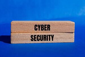 Cyber security message written on wooden blocks with blue background. Conceptual cyber security symbol. Copy space. photo