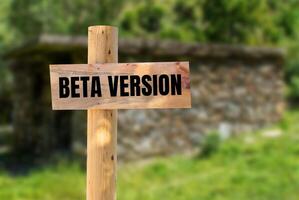 Beta version message written on wooden sign with nature background. Conceptual beta version symbol. Copy space. photo