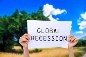Global recession message written on white paper with nature background. Conceptual global recession symbol. Copy space. photo