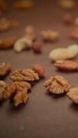 A delightful mix of fresh assorted nuts on a wooden table, ideal for snacking or baking video