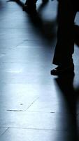The image shows silhouetted feet on a reflective surface, creating intriguing visual contrast video