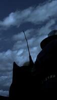 A mysterious figure stands silhouetted dramatically against the backdrop of dark, ominous clouds video