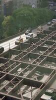 A bustling urban traffic scene with vehicles navigating an overhead structure in the city video