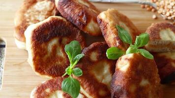 cooked fried pea pies on a wooden board video