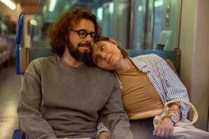Young romantic tourist couple is travel together while riding in public bus photo