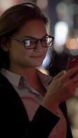 A professional woman confidently using her smartphone while navigating an urban environment video