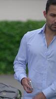 A man is using a smartphone while in a relaxed casual setting, seeming very engaged and focused video