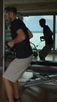 A man exercising diligently with dumbbells in a modern and wellequipped gym environment video