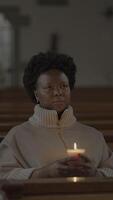A Contemplative Moment Inside a Quiet Church, Illuminated by Soft and Warm Candlelight video