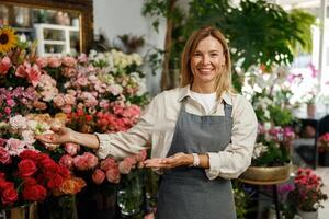 Smiling woman florist small business owner standing in own floral store and waiting for client photo