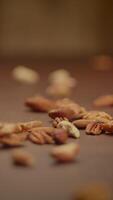A CloseUp View of Various Raw Nuts Spread Out on a Rustic Wooden Surface to Enjoy video