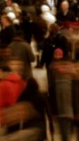 This is a vibrant and crowded urban scene where numerous people are in constant, lively motion video