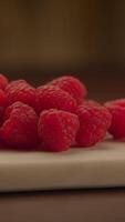 A delightful arrangement of fresh raspberries beautifully displayed on a cutting board video