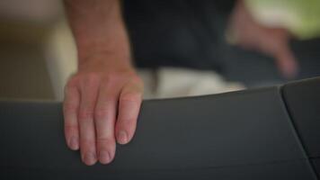 A hand gently resting on the edge of a chair, beautifully illuminated by soft lighting video
