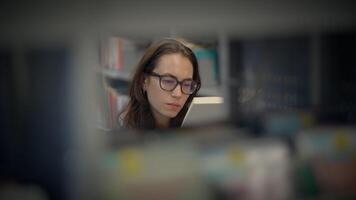 A Focused Woman Deeply Engaged in Reading Within a Calm Library Environment Setting video