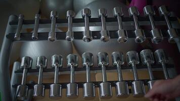 Diverse Array of Dumbbells in a Modern Fitness Studio for Various Workout Routines video