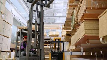 Forklift loader in storage lumber warehouse. Distribution products. Delivery. Logistics. Transportation video