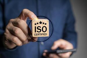 ISO standards quality control. Businessman use smartphone with quality assurance with five stars or guarantee product. photo